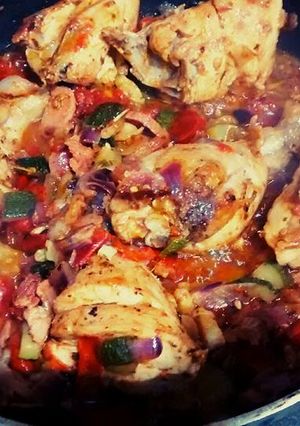 A picture of Chicken and Veggies in a Pan.