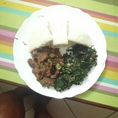 A picture of Ugali, steamed greens, beef stew.