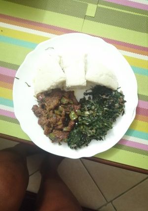 A picture of Ugali, steamed greens, beef stew.