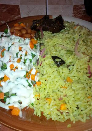 A picture of Fried rice and coleslaw and beef.