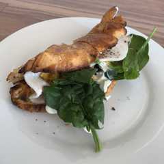 A picture of Croissant + chicken breast + scramble egg.