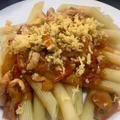 A picture of Penne with Chicken and mushrooms in tomato sauce.
