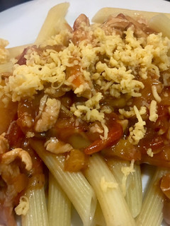 A picture of Penne with Chicken and mushrooms in tomato sauce.