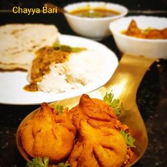 A picture of Modak Aamti with Rice and Jowar roti.