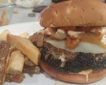 Unique Cuisine Beef Lamb and Feta Burger with Provolone Caramelized Onions and Russian Horseradish Dressing served with Garlic Fries Delicious