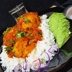 A picture of Green bananas(matoke) balls served with rice.