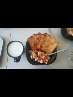 A picture of Toasted bread with kachumbari served with white coffee.