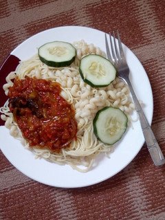 A picture of White spaghetti and macaroni with tomato sauce.