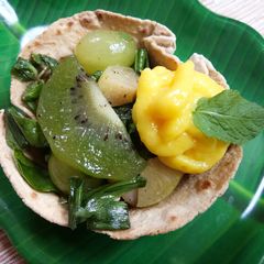 A picture of Green salad with custard in tortilla cups.