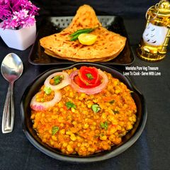 A picture of Punjabi Moong Masala Curry With Triangle Paratha.