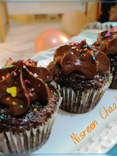 A picture of Cocoa Cupcakes with Chocolate Buttercream.