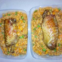 A picture of Jollof rice with vegetables and turkey.
