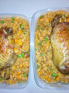 A picture of Jollof rice with vegetables and turkey.