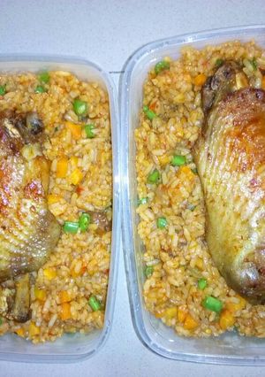 A picture of Jollof rice with vegetables and turkey.