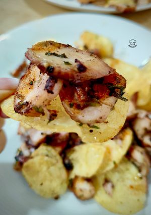 A picture of Garlic Squid with Lemon-Pepper Dressed Potato Chips.