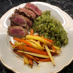 A picture of Steak with brocolli mash and parsnip/carrot fries.