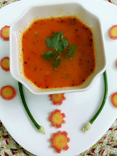 A picture of Carrots and tomato soup.