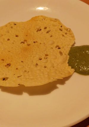 A picture of Papad and mint curd Chutney.