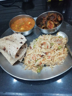 A picture of Pea curry Pulao Karela and chapati.