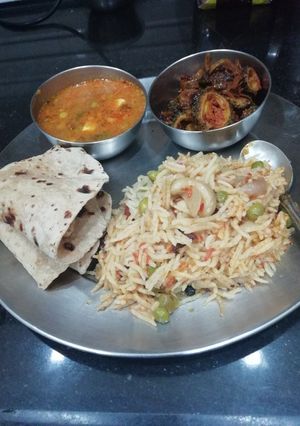A picture of Pea curry Pulao Karela and chapati.