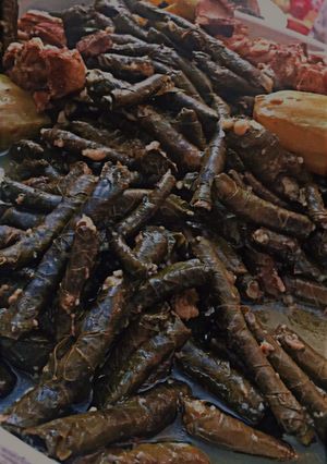 A picture of Stuffed Grape Leaves with Lamb Chops.