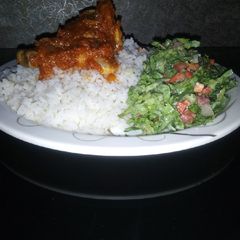 A picture of Rice and stew with salad.
