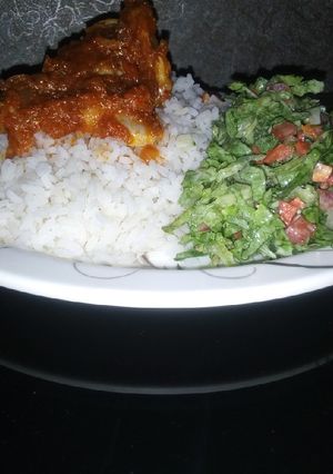 A picture of Rice and stew with salad.