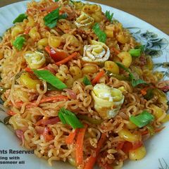 A picture of Maggi noddels with veggies and egg.