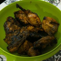 A picture of Grilled chicken on charcoal.