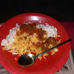 A picture of Rice and palm oil stew.