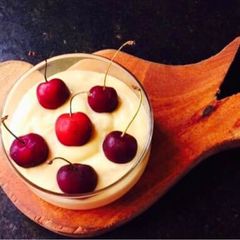 A picture of Mango cream with cherries.