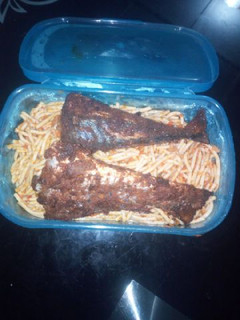 A picture of Spagetti with fried fish.
