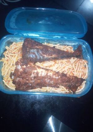 A picture of Spagetti with fried fish.