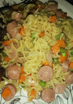 A picture of Noodles with sausage and veggies.
