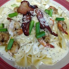 A picture of Shrimp and bacon cheesy Alfredo.