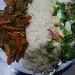 A picture of Rice with shredded beef sauce.