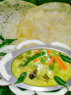 A picture of Appam with vegetable stew.