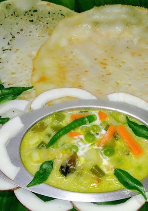 A picture of Appam with vegetable stew.