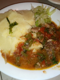 A picture of Mashed potatoes with beef stew.