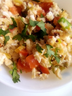 A picture of Simple scrambled eggs with onions, tomatoes and capsicum.