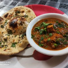 A picture of Matar paneer dhaba style with wheat flour butter naan.