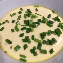 A picture of Steamed Egg with Crabstick and Spring Onion.
