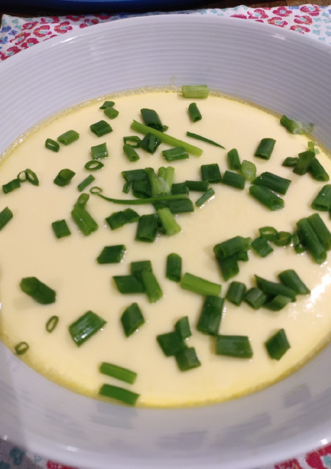 A picture of Steamed Egg with Crabstick and Spring Onion.