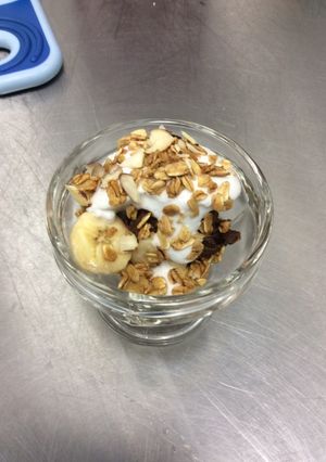 A picture of Raw Chocolate Banana Mousse Parfait with Coconut Whip Cream and Vanilla Almond Granola.