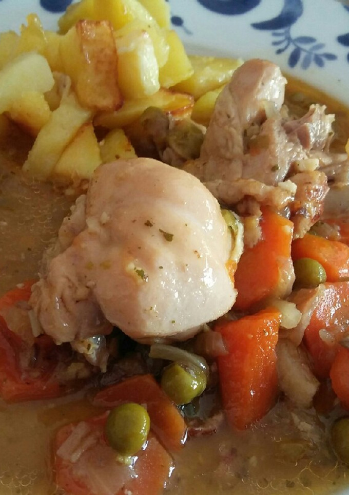 Una foto de Pollo en salsa de verduras y patatas fritas
