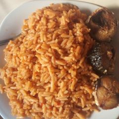 A picture of Jollof rice with fried fish.