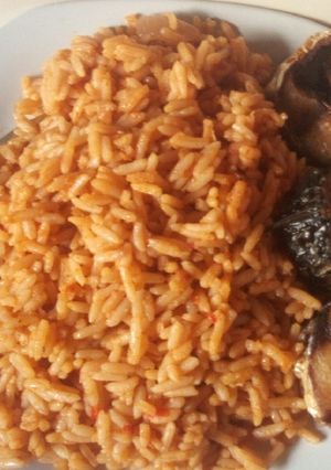 A picture of Jollof rice with fried fish.