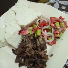 Dry fry beef with kachumbari and ugali A picture of Dry fry beef with kachumbari and ugali.