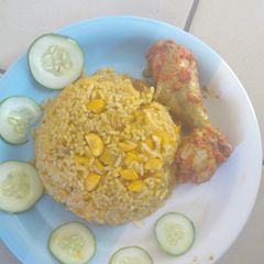 A picture of Jollof rice and chicken stew.