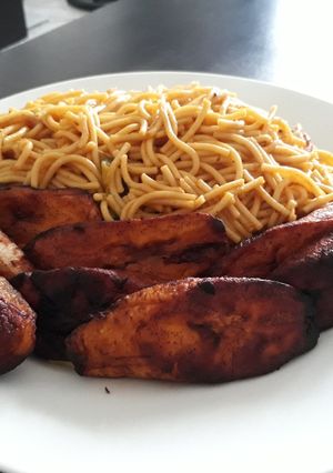A picture of Spagetti with fried plantain.